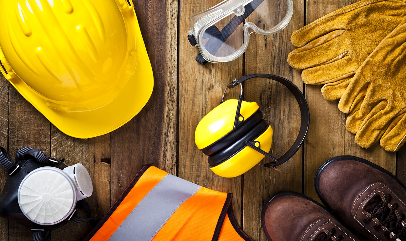 Personal safety workwear on rustic wood background shot directly above